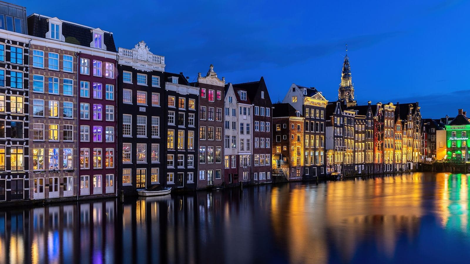 Canal houses reflected in the water at blue hour, Amsterdam