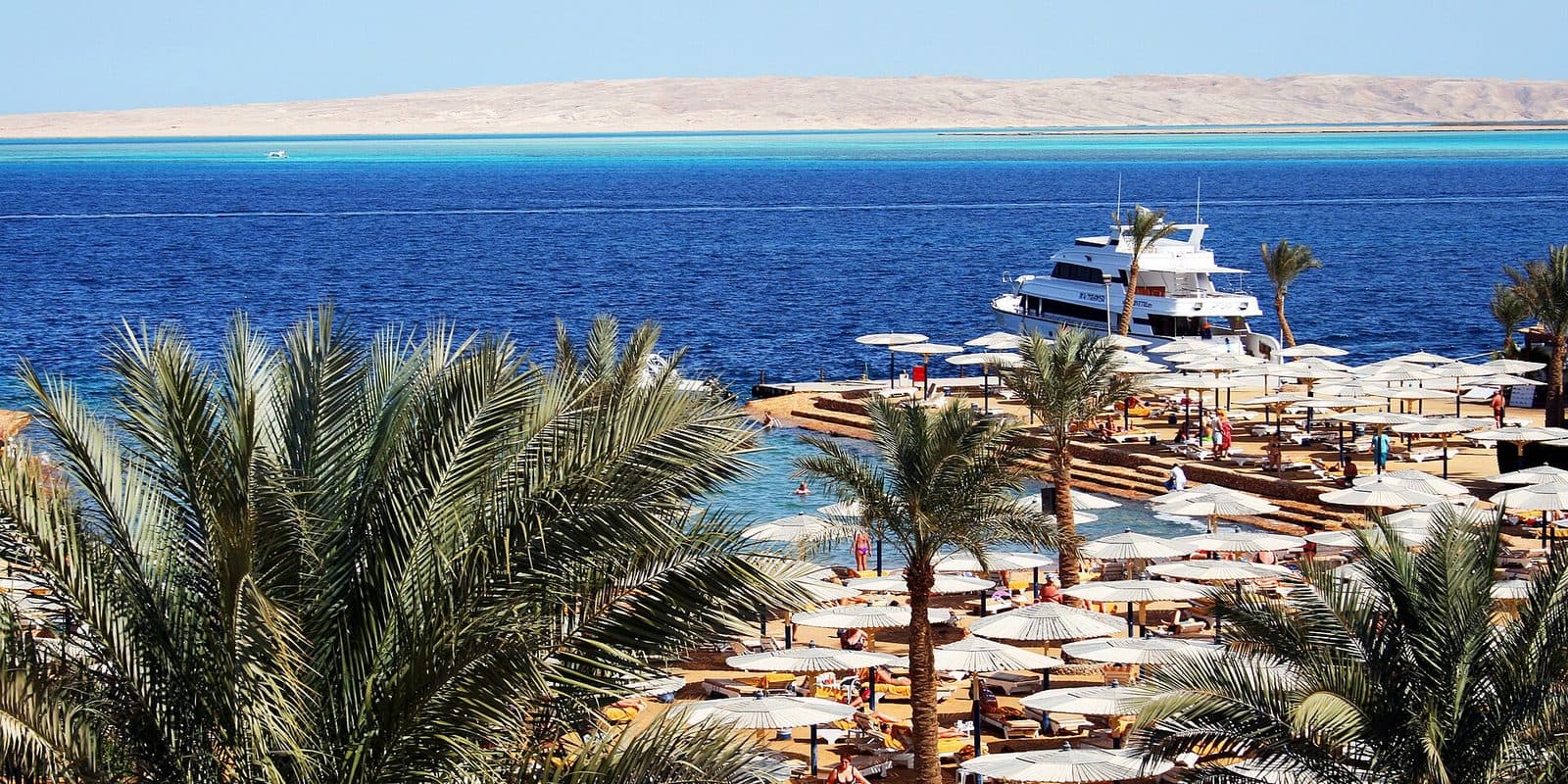 Palm trees and a hotel beach with a small marina on the Red Sea at Hurghada, Egypt