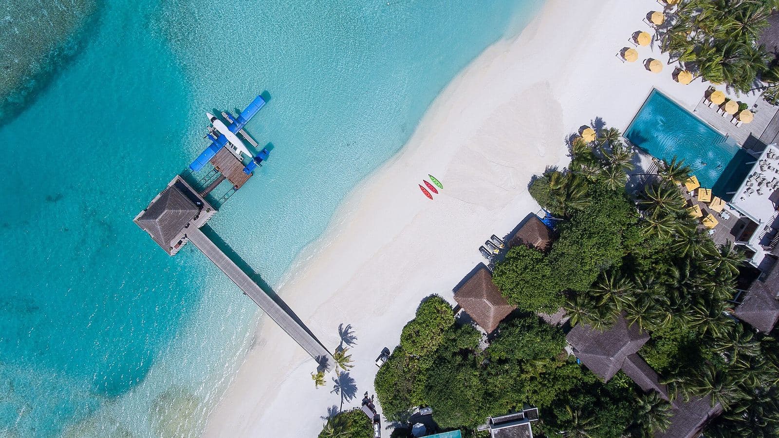 Overwater bungalows on a Maldives atoll, aerial view
